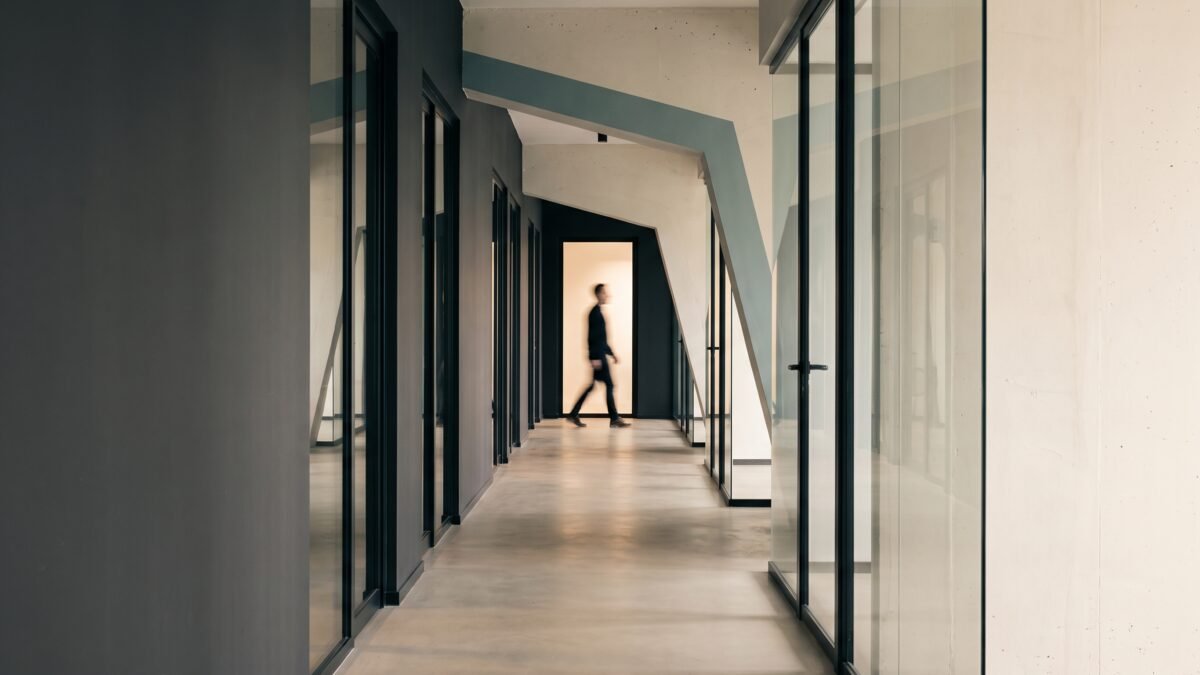 figure walking in office corridor 2k 202609041542
